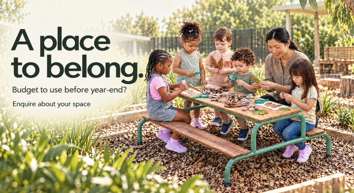 A family enjoys a picnic-style wooden table with green metal legs in an outdoor garden setting. Large text on the left reads, 'A place to belong.